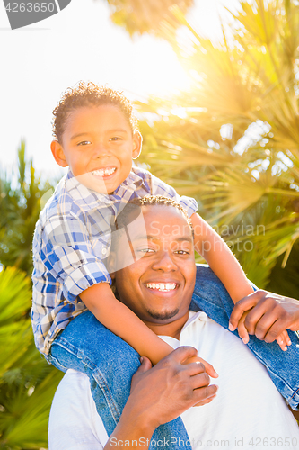 Image of Mixed Race Son and African American Father Playing Piggyback Out