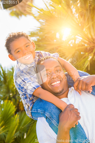 Image of Mixed Race Son and African American Father Playing Piggyback Out