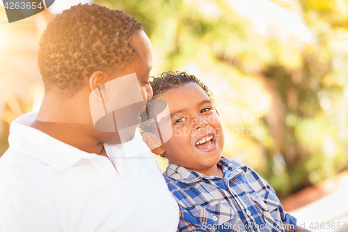 Image of Mixed Race Son and African American Father Playing Outdoors Toge