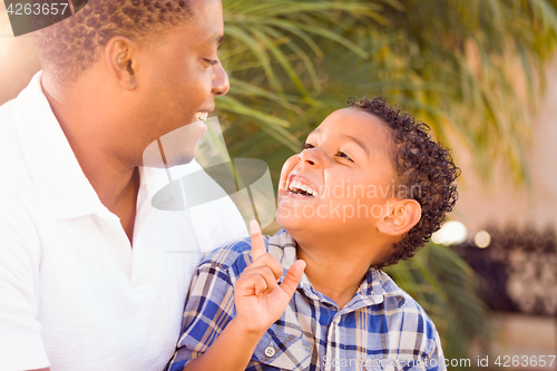 Image of Mixed Race Son and African American Father Playing Outdoors Toge