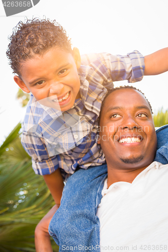 Image of Mixed Race Son and African American Father Playing Piggyback Out