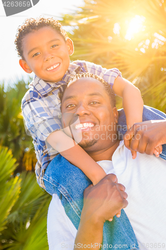 Image of Mixed Race Son and African American Father Playing Piggyback Out