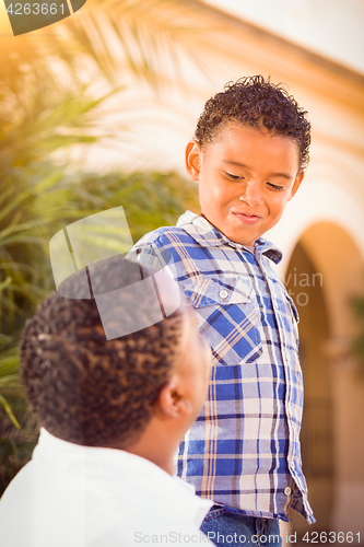 Image of Mixed Race Son and African American Father Playing Outdoors Toge