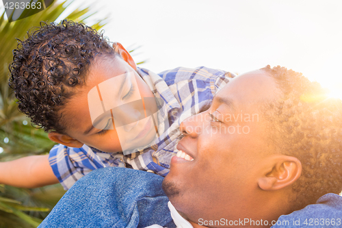 Image of Mixed Race Son and African American Father Playing Piggyback Out