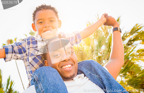 Image of Mixed Race Son and African American Father Playing Piggyback Out