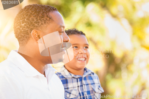 Image of Mixed Race Son and African American Father Playing Outdoors Toge