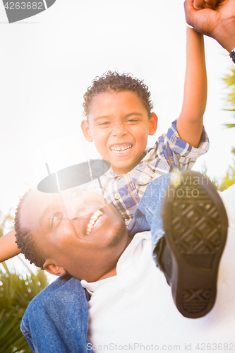 Image of Mixed Race Son and African American Father Playing Piggyback Out