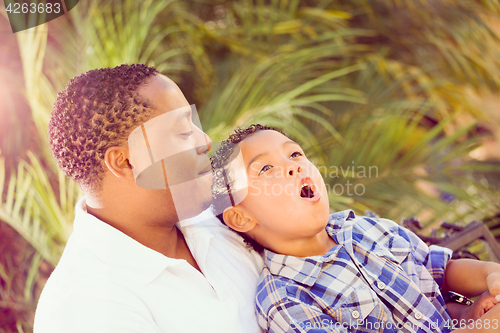 Image of Mixed Race Son and African American Father Playing Outdoors Toge