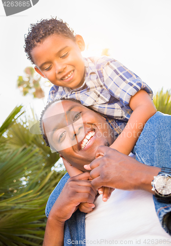 Image of Mixed Race Son and African American Father Playing Piggyback Out