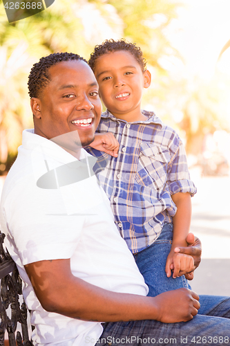 Image of Mixed Race Son and African American Father Playing Outdoors Toge