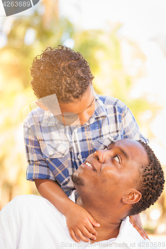 Image of Mixed Race Son and African American Father Playing Outdoors Toge