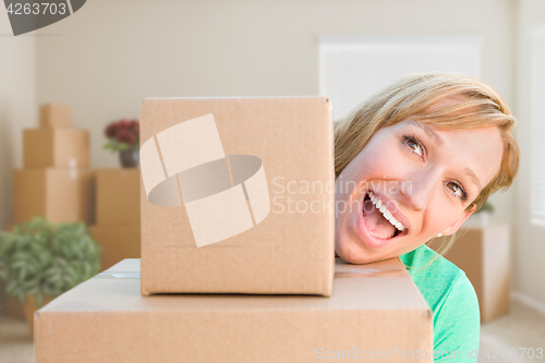 Image of Happy Young Adult Woman Holding Moving Boxes In Empty Room In A 