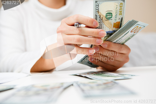 Image of Hands counting money, close up