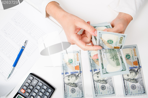 Image of Hands counting money, close up