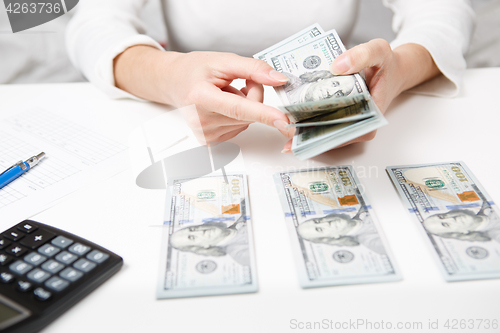 Image of Hands counting money, close up