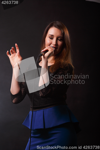 Image of Long haired girl with microphone