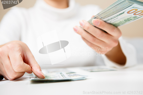 Image of Hands counting money, close up