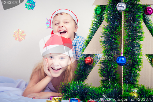 Image of Happy little smiling boy and girl with christmas hat.