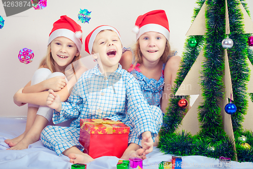 Image of Happy little smiling boy and girls with christmas hat.