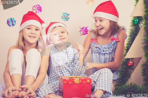 Image of Happy little smiling boy and girls with christmas hat.