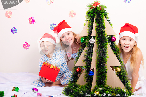 Image of Happy little smiling boy and girls with christmas hat.