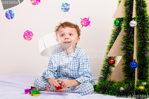 Image of Happy little smiling boy with christmas gift box.