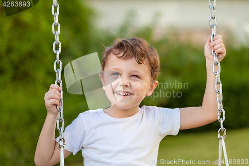 Image of happy little boy playing on playing on the playground 