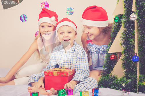 Image of Happy little smiling boy and girls with christmas hat.