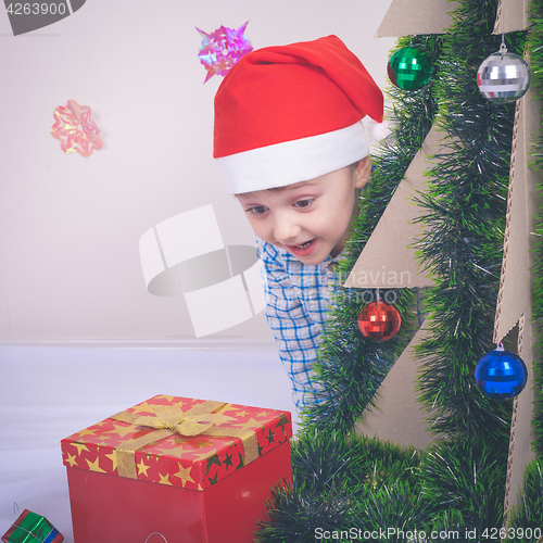 Image of Happy little smiling boy with christmas gift box.