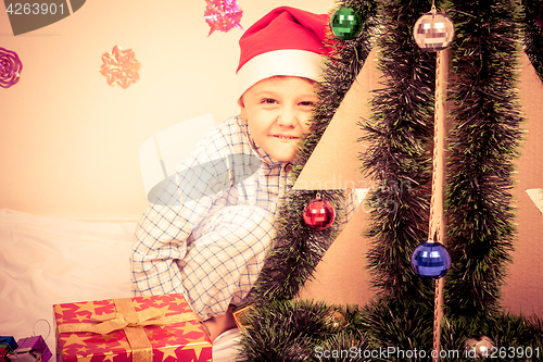 Image of Happy little smiling boy with christmas gift box.