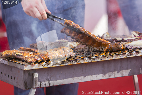 Image of Chef bbq grilled pork ribs on smoke