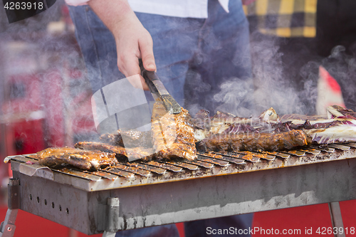 Image of Chef bbq grilled pork ribs on smoke