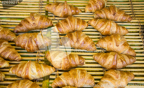 Image of Freshly baked French croissants in street bakery store 