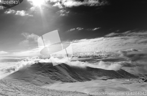 Image of Black and white view on off-piste slope in clouds and sky with s