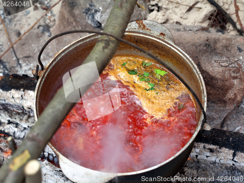 Image of Borscht (Ukrainian traditional soup) cooking in sooty cauldron