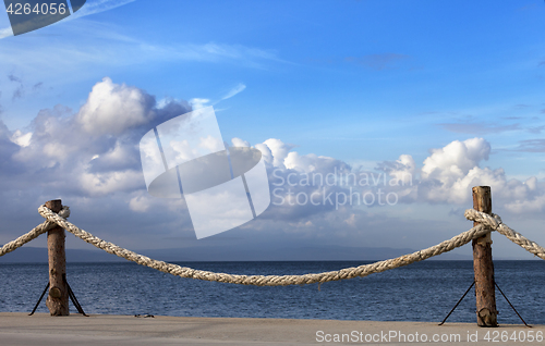 Image of Seafront and sky with sunlight clouds in autumn evening