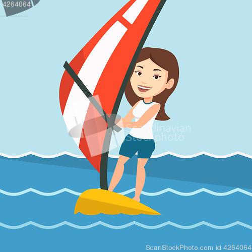 Image of Young woman windsurfing in the sea.