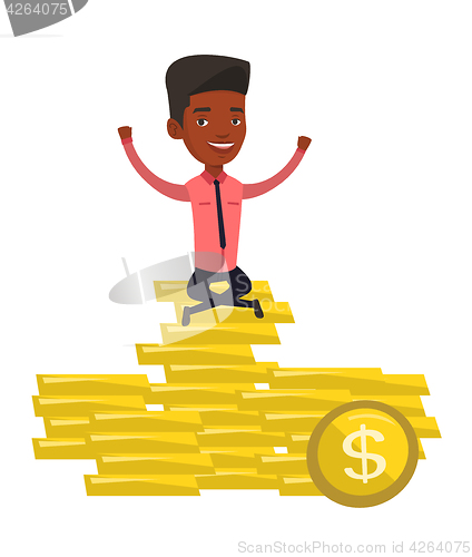 Image of Happy businessman sitting on golden coins.