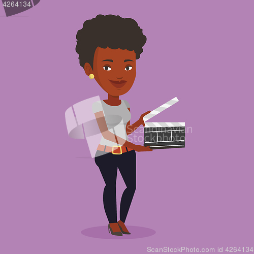 Image of Smiling woman holding an open clapperboard.