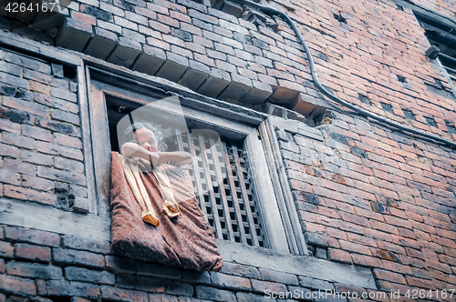 Image of Child in window in Nepal