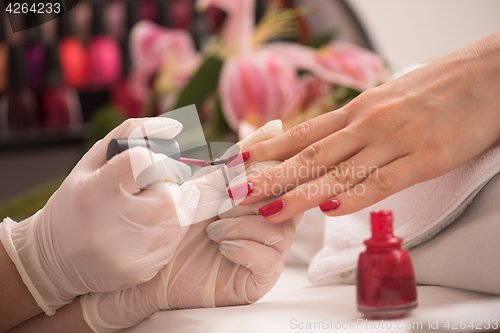 Image of Woman hands receiving a manicure