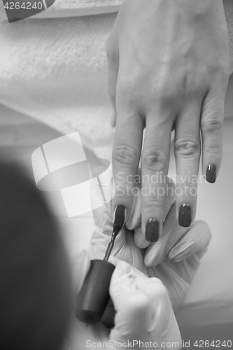 Image of Woman hands receiving a manicure