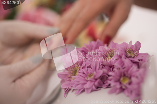 Image of Woman hands receiving a manicure