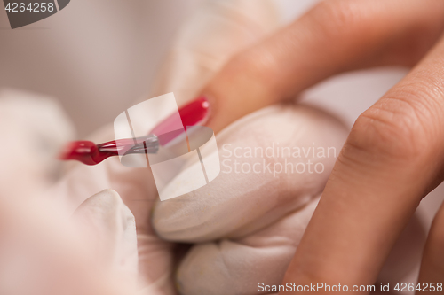 Image of Woman hands receiving a manicure