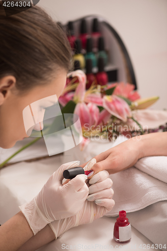 Image of Woman hands receiving a manicure