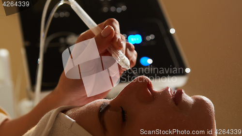 Image of Face Beauty Treatment. Closeup Of Beautiful Woman Getting Facial Gas-liquid Oxygen Water Epidermal Peeling Using Professional Equipment At Cosmetology Center. Skin Care Concept.