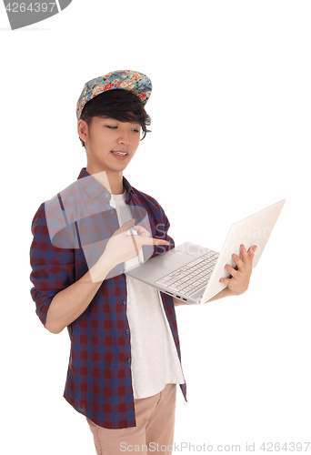 Image of Asian teenager pointing at his laptop.