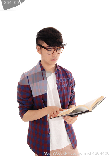 Image of Young Asian man reading book.