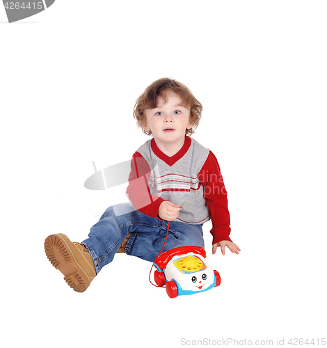 Image of Portrait of little boy with his toy phone.