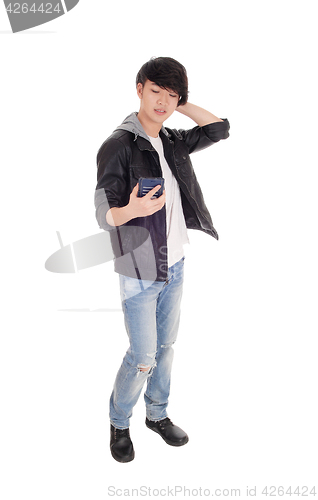 Image of Asian teenager looking at his cellphone.